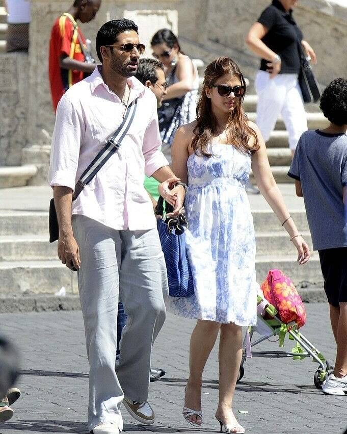 Aishwarya Rai's Old Vacay Pics With Abhishek Bachchan, Amitabh & Jaya Take Over The Internet One photo captured Aishwarya and Abhishek holding hands on the streets of Europe, with Aishwarya in a floral dress and Abhishek in a pink shirt and grey trousers.
