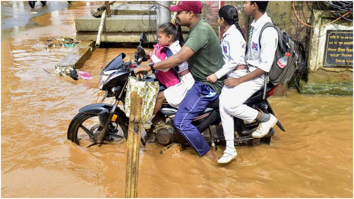 In some parts of Guwahati, people navigated knee-deep water in certain areas, while in others, floodwaters reached chest height. (Source: PTI)