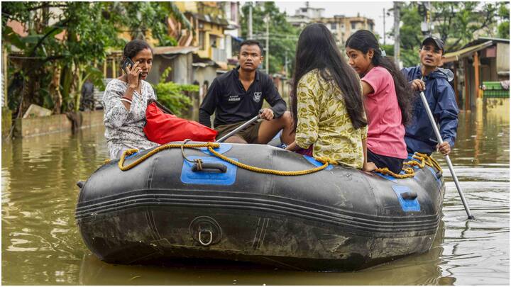 People stranded in heavy rain in Guwahati were seen using lifeboats for assistance. (Source: PTI)