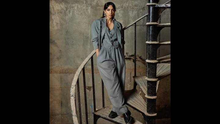 2. Sobhita Dhulipala: Sobhita Dhulipala opted for a vintage-inspired outfit. She styled her grey three-piece suit with elegance. It featured a relaxed blazer with structured waistcoat and a high-waisted trouser. The actress served a refined look which she elevated with a bold touch of accessories, consisting of statement metallic earrings and black loafers. She served a standout moment in her monochromatic look with detailing and charm. (Image Source: Instagram/@sobhitad)