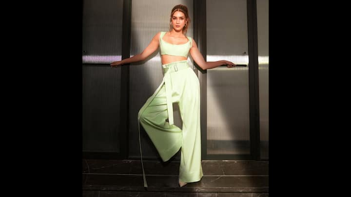 5. Kriti Sanon: Kriti Sanon wore a stunning mint green monochrome outfit that gave a chic and refreshing look to the actress. The modern minimalistic aesthetic featured a structured crop top and a high-waisted wed-leg trousers. The crop top had broad straps with a flattering neckline while the trousers had a statement elongated belt that added a polished finish. The actress opted for minimal accessories which radiated a relaxed vibe. She completed her look with white heels that elevated her overall attire. (Image Source: Instagram/@kritisanon)