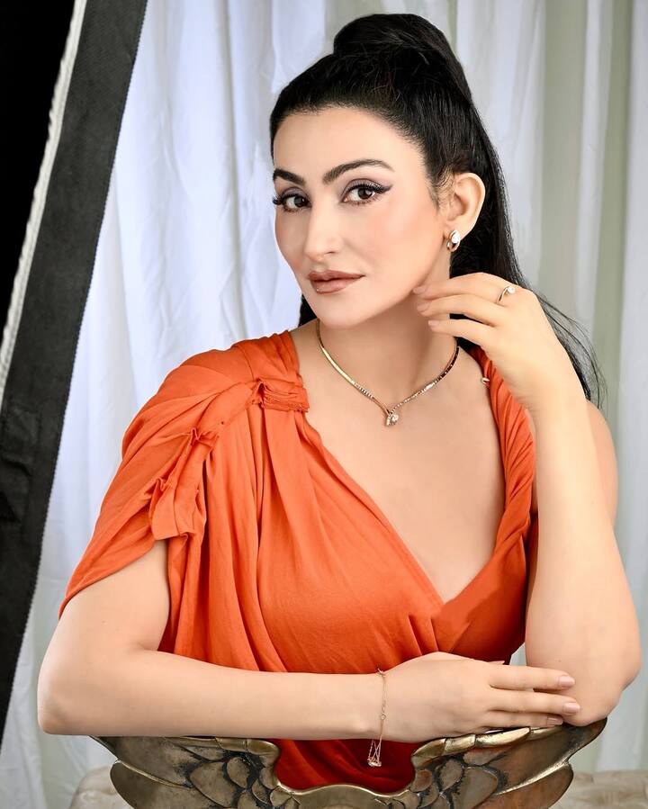 This shoot evokes a vibe of high-end elegance fused with bold individuality. The white draped backdrop ensures the orange hue and Shalini’s expressions are the focal points. The set design, particularly the eagle-winged chair, adds a touch of mystique and power to the composition—mirroring Shalini's role as a prominent figure in the arts and fashion world.( All Pics Credit: Instagram/@shalini.passi)