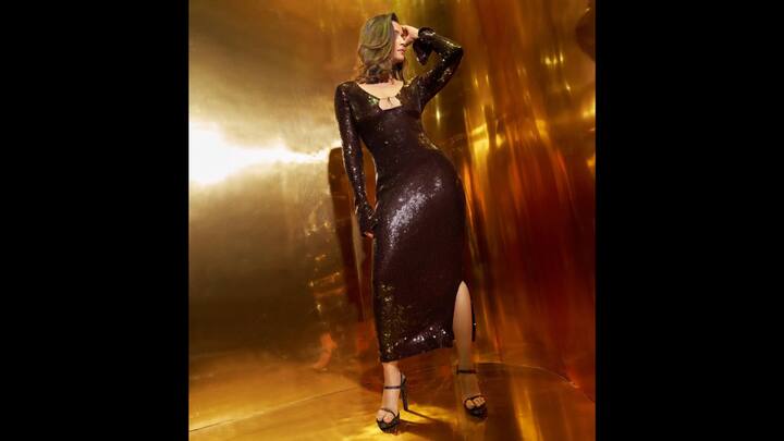 4. Black Bodycon Dress: Alia Bhatt opted for a black sequin bodycon dress that had a figure-hugging silhouette. The shimmering fabric exuded bold elegance and created a dazzling effect. The subtle front keyhole detail and a side slit added drama to the sleek look. This black sequin outfit proved that Alia Bhatt can ace any fashion moment with confidence. (Image Source: Instagram/@aliaabhatt)