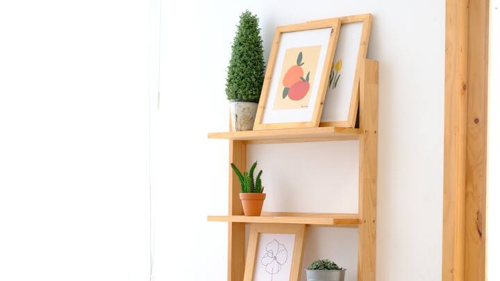 Vertical is the New Horizontal: Why waste space when you can build up? Use tall shelves, hang racks, or mount units onto walls to free up otherwise cluttered floor space. (Image Source: Canva)