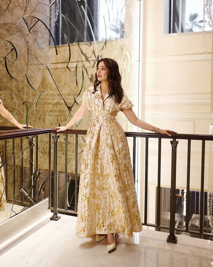 She completed her look with a pair of sleek, glossy white stilettos that added a touch of polished sophistication.