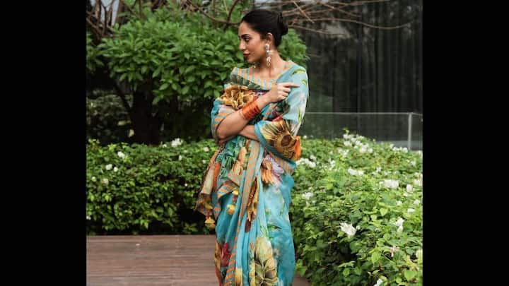 In this silk organza saree adorned with firoza blue floral prints, Sobhita appeared dreamy and divine. Adding to this charming look was a strappy blouse with geometric motifs, pearl earrings, and flowers in her bun, giving it a delicate vintage touch. (Image Source: Instagram/ sobhitad)