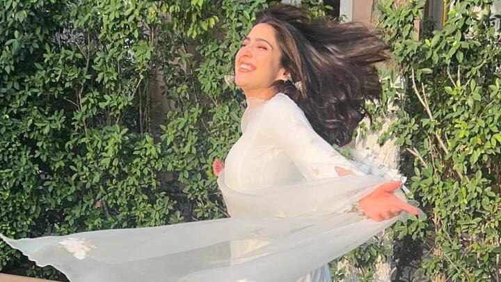 Sara ali khan's white Anarkali suit with straight pants and an embroidered dupatta is ideal for a traditional yet relaxed Bakrid look. Her oxidised jhumkas and white juttis complete the festive look. (Image Source: Instagram/ saraalikhan95)