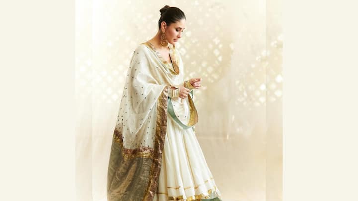 Kareena kapoor stuns in this white Anarkali suit with intricate metal gota detailing and silk zari work, an elegant ensemble to brighten up your Bakrid celebrations. Gold jhumkas and juttis complete her graceful ethnic look. (Image Source: Instagram/ kareenakapoorkhan)