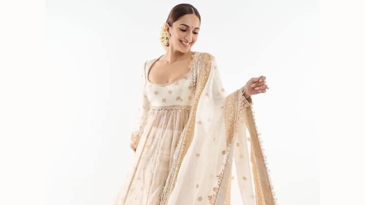 Kiara Advani shines bright in this off-white and gold Anarkali, which sets it ablaze as a festival-worthy pick for Bakrid celebrations. The 16 zari-embroidered panels and the full sleeves embroidered with gold floral motifs are simply festive and elegant. (Image Source: Instagram/ manishmalhotraworld)