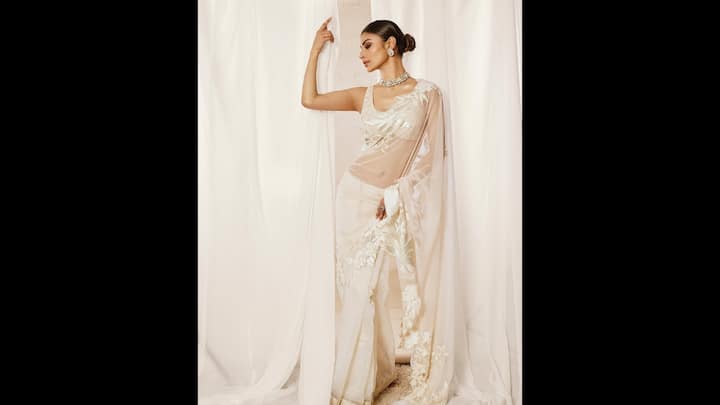 2. Mouni Roy: Mouni Riy wore an ethereal white saree that served as a dreamy choice of the Bakrid festivities. The subtle shimmer and floral embroidery on the saree added a touch of glamour to it while the intricate threadwork along the borders enhanced elegance. The actress complemented her sheer drape with statement jewellery pieces that made her look stunning and festive ready. (Image Source: Instagram/@imouniroy)
