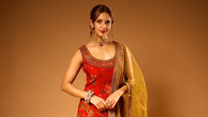 Tripti Dimri stuns in this regal red and olive velvet suit set, adorned with delicate wildflower embroidery. The luxurious fabric and earthy tones make it a perfect choice for Bakrid celebrations, blending tradition with sophistication. (Image Source: Instagram/ tripti_dimri)