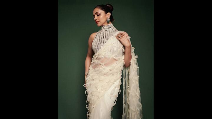 8. Deepika Padukone: Deepika Padukone wore a ruffled textured sheer saree that consisted of scattered 2D floral embellishments. The contemporary saree gave the actress a unique look with the couture and soft drape. The sleeveless, high neck blouse was adorned with silver embellishments which made the outfit a standout element. The actress completed her look with statement green and silver earrings, adding a festive sparkle to the ethnic attire. (Image Source: Twitter/@TheQueenDP)