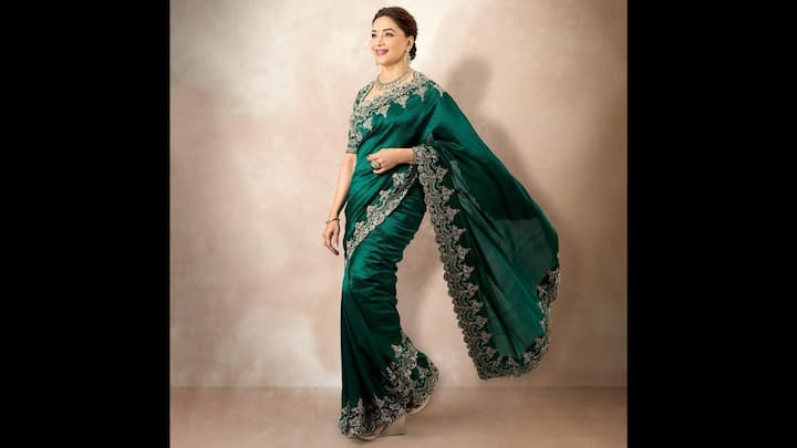 5. Madhuri Dixit: Mudhuri Dixit wore an emerald green saree which radiated a regality. The saree was adorned with intricate silver embroidery along the borders, giving it a royal touch. The sheen of the fabric added elegance to the traditional fit. Madhuri complemented her green saree with traditional jewellery which elevated the outfit, making it festive ready. (Image Source: Twitter/@filmfare)