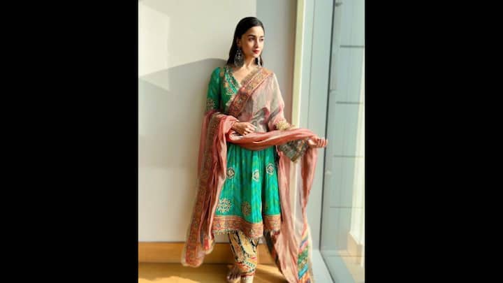 2. Alia Bhatt: Alia Bhatt's vibrant green ethnic ensemble served as a stunning blend of tradition and festive flair. The suit featured a heavily embroidered kurta that was adorned with golden motifs and a rich border. She paired the kurta with an intricately designed salwar that added a regal charm to the look. The contrasting dupatta was adorned with delicate zari work and multi-hued border, added elegance and texture to the fit. This outfit of Alia Bhatt is ideal for anyone who wants to keep the look classic yet eye-catching this Eid. (Image Source: Pinterest/@josephinemalik_)