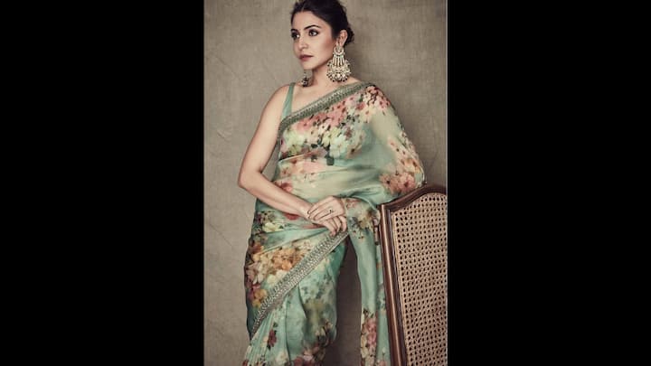 1. Anushka Sharma: Anushka Sharma looked elegant in her soft green floral saree, making it a perfect pick of an Eid celebration. The sheer organza fabric draped gracefully with the delicate floral prints in pastel added a refreshing and romantic touch to the fit. The saree was paired with a sleeveless matching blouse. She accessorised her traditional look with statement earrings which added the right amount of sparkle. The modest, yet fashionable attire was light in appearance but highlighted the saree's elegance. (Image Source: Instagram/@anushkasharma)