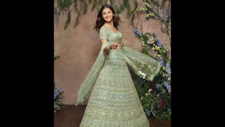 6. Alia Bhatt: The pistachio green lehenga worn by Alia Bhatt is the ideal summer traditional fit. The embellished outfit, featuring shimmering threadwork, sequin detailing and more. Her matching blouse had a flattering sweetheart neckline that paired with her lehenga beautifully. Styled with matching bangles, stunning ring, and delicate maang tikka, Alia Bhatt proved the understated glamour always wins. (Image Source: Pinterest/keshariruby68)