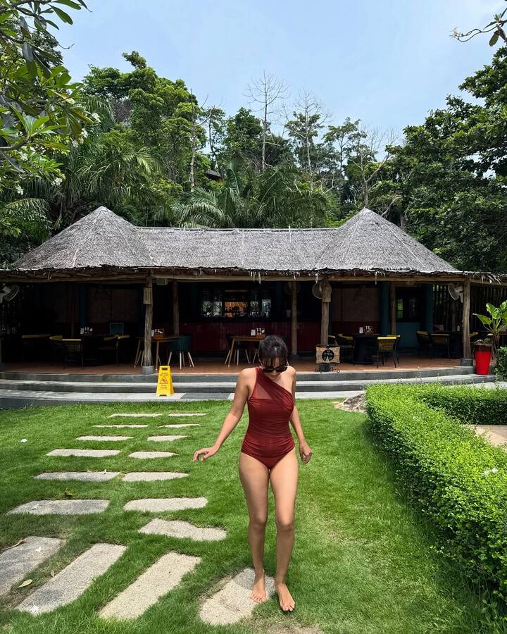 Surbhi stuns in a rust one-shoulder monokini featuring sheer detailing on one side.