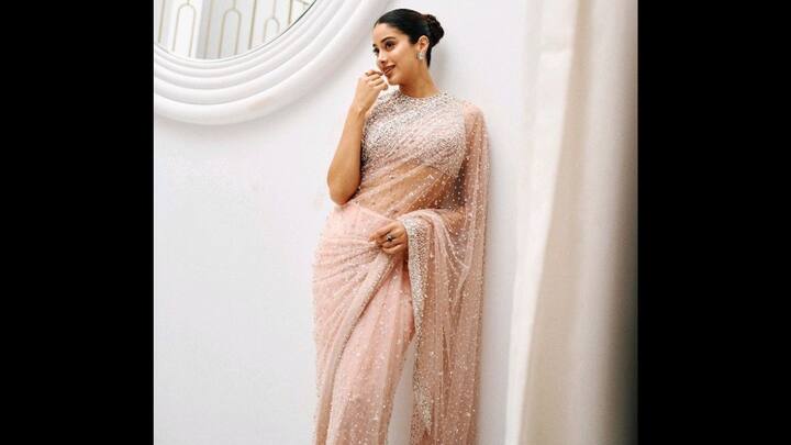 5. Janhvi Kapoor: Janhvi Kapoor wore a blush pink pastel saree that served as a dreamy fusion of vintage charm and modern sophistication. Ideal for Eid and other festivities, the saree was adorned with sequin work and pearl embellishments. The actress wore a high neck blouse that was encrusted in crystals, bringing a regal finish. She opted for minimal accessories which featured diamond studs and matching rings, which enhanced the overall aesthetic. (Image Source: Pinterest/shahmm140268)