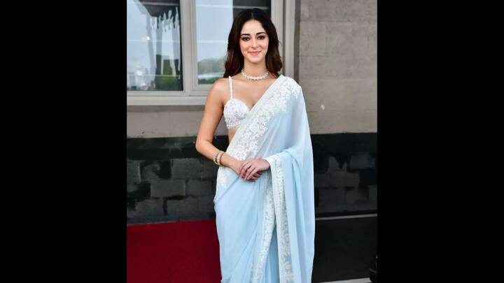 7. Ananya Panday: Wearing a pastel saree, Ananya Panday proved that elegance lies in simplicity. Draped in a pastel hued saree adorned with delicate lace embroidery, the actress blended modern glamour with tradition. She opted for a sleek bangles and a peal choker necklace to elevate her ethnic look. The noodle strap blouse had intricate and delicate floral detailing that added a contemporary touch. (Image Source: Pinterest/nand777)