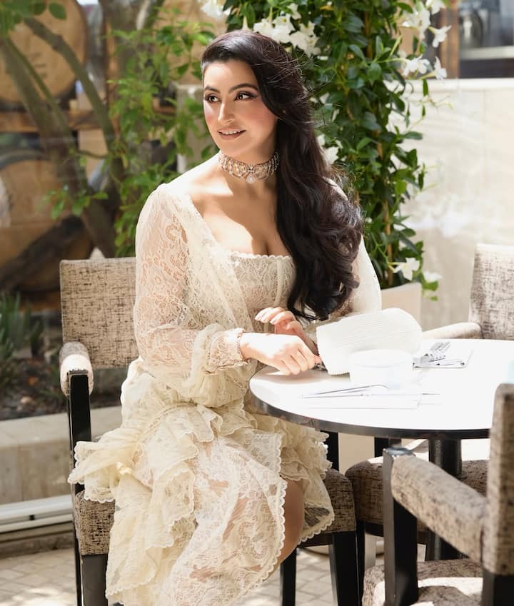 The outfit, a coordinated set featuring a sheer lace blouse with full sleeves and a ruffled high-low hem skirt, gave a nod to Victorian romanticism while remaining contemporary in its tailoring and silhouette.