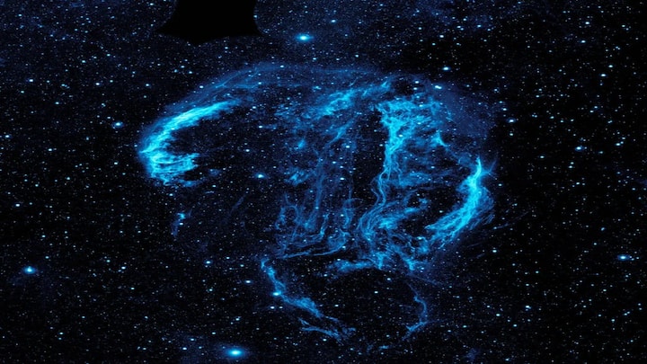 A 20,000-year-old supernova remnant roughly 2,400 light-years from Earth. The Cygnus Loop spans 120 light-years and glows in delicate, thread-like arcs. NASA's telescopes reveal it in ultraviolet and optical light.