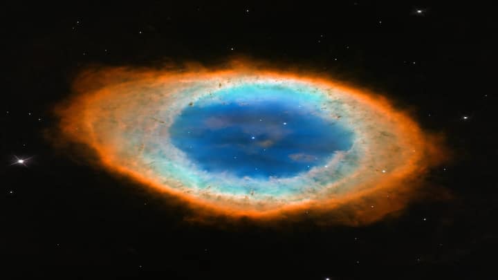 Located about 2,500 light-years away in the Lyra constellation, the Ring Nebula is a glowing shell of gas ejected by a dying star. Though it looks like a perfect ring, recent JWST images reveal a more complex three-dimensional structure.