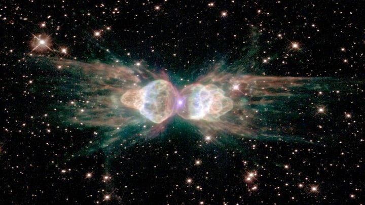 The Ant Nebula gets its name from twin lobes of gas that look like an insect’s body. It’s actually a planetary nebula—created by a dying Sun-like star. Captured by Hubble, its symmetry is likely caused by tightly bound stars or magnetic fields.
