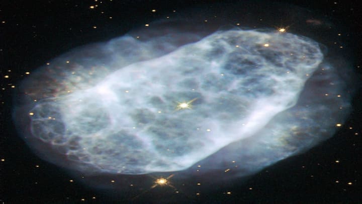 NGC 6153 is a faint planetary nebula in the Scorpius constellation, around 4,000 light-years from Earth. It is known for containing unusually hot ionized gas, offering astronomers clues about the thermal structure of dying stars.