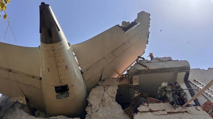 The tail section of the plane became lodged on the top floor of the hostel, penetrating deep into the structure. (Image Source: x/ ANI)