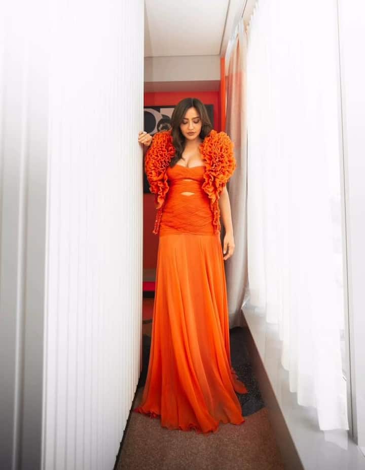 Neha Sharma made heads turn in a statement orange voluminous gown from Supria Munjal.