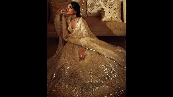 6. Sonam Kapoor: Dressed in a dazzling creation, Sonam channeled old-world royal elegance with a modern sparkle that’s impossible to ignore. This ivory-toned lehenga is a masterpiece in mirror work craftsmanship. With intricate gota patti, hand-embroidered detailing, and dazzling reflective embellishments from hem to dupatta, the outfit gave a celestial aura. The voluminous skirt, paired with a deeply cut blouse and an equally embellished dupatta, blended heritage silhouettes with contemporary styling. With her hair in a sleek middle-parted bun, statement jadau jewellery, and glowing makeup, she allowed the outfit take centre stage while exuding timeless sophistication. (Image Source: Instagram/@sonamkapoor)