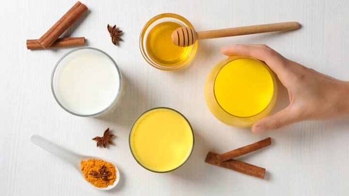 4. Turmeric Milk: This golden drink has warmed Indian households for generations. Now known as 'Golden Latte,' this immunity-boosting drink is made with turmeric, milk, black pepper, and sometimes ghee or ginger. It's a natural anti-inflammatory and antioxidant-rich beverage. Turmeric contains curcumin, known for reducing joint pain and aiding digestion. Drinking turmeric milk before bedtime also helps improve sleep quality, ease anxiety, and soothe sore muscles. (Image Source: Canva)