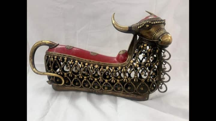 5. Dokra Nandi: Presented by PM Modi to French President Emmanuel Macron, this exquisite piece originates from Tamil Nadu. Crafted using the ancient lost-wax casting technique, the sculpture features Nandi, the sacred bull and loyal companion of Lord Shiva. The bull has an openwork lattice design, which is a hallmark of the Dokra style. The finely etched patterns on its body showcase the skill of Indian artisans, while a vibrant red saddle adds a pop of color and cultural richness to the otherwise antique brass finish. (Image Source: Twitter/@ANI)
