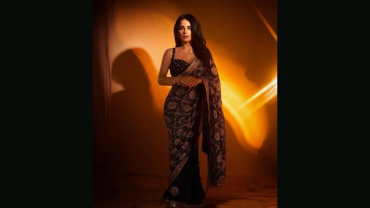 7. Radhika Madan: Redefining contemporary festive fashion with a nod to Indian heritage, Radhika Madan served an elegant look. Drenched in a deep, jewel-toned hue, the saree showcased traditional Bandhani patterns adorned with dazzling mirror-work floral motifs, making it a bold pick for evening celebrations. The shimmering gotta patti and sequin border added a luxe finish, while the fitted embellished blouse modernised the classic silhouette. (Image Source: Instagram/@faabiianaindia)