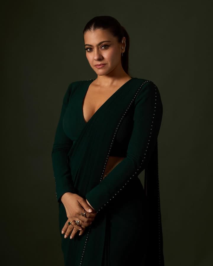 Kajol's saree came with a sleek, full-sleeved blouse featuring a plunging V-neck and bold backless detailing.