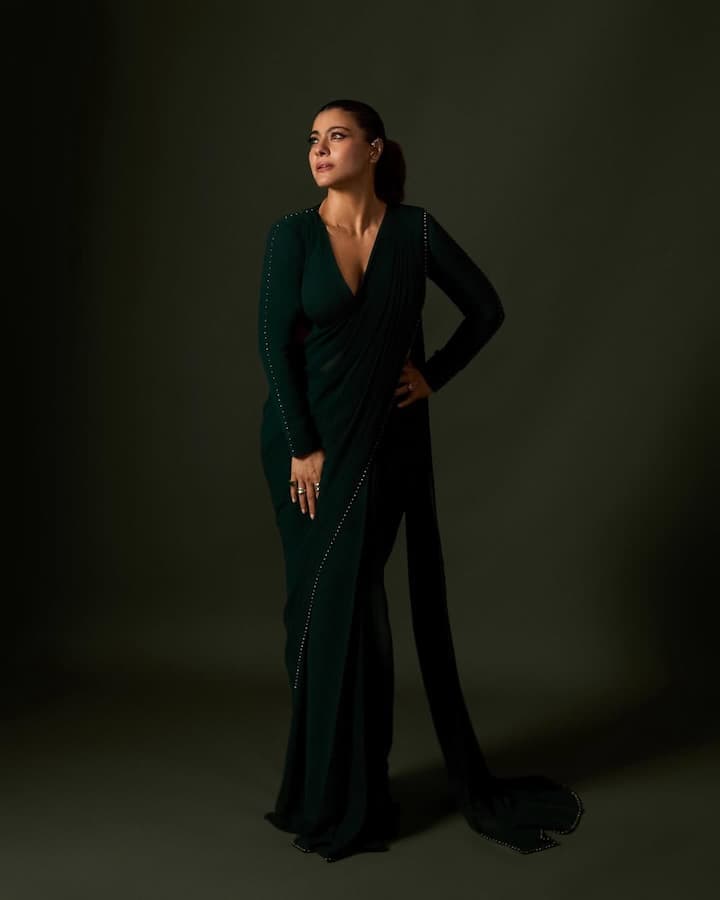 Kajol stunned in a deep green saree with a modern twist. The drape gave gown-like feels with its sculpted silhouette.