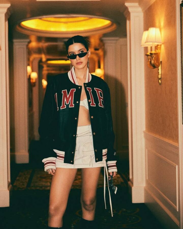 Shanaya Kapoor: Cool and edgy, Shanaya pairs a white bralette with a printed mini skirt, topping it with a black leather jacket for that streetwear-meets-chic vibe.