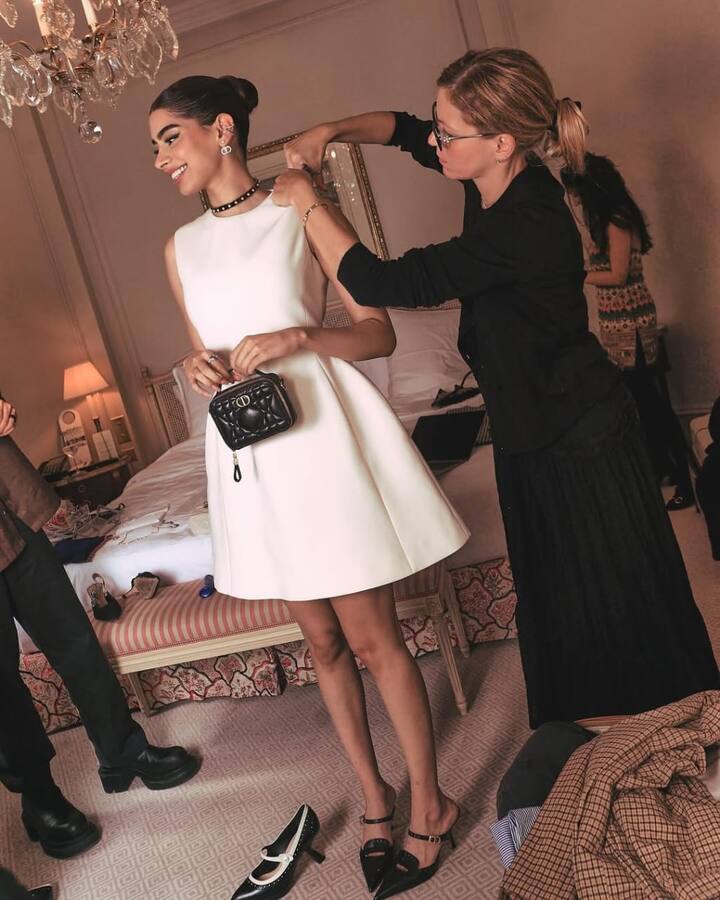Khushi Kapoor: Khushi keeps it sleek and graceful in a pristine white Dior dress with structured sleeves and a soft flare. The elegance of the look is enhanced with a black Dior mini bag, a contemporary choker, and silver jewellery. A neat bun and understated glam give this ensemble a polished, timeless vibe.
