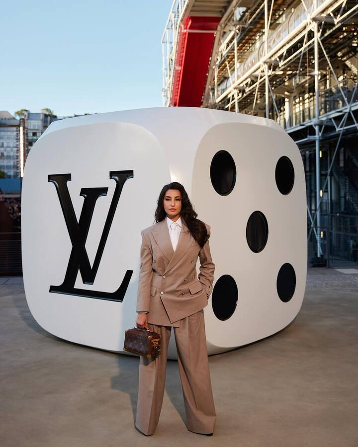 At Paris Fashion Week, Nora Fatehi turned heads and made a powerful fashion statement, channeling fierce boss lady energy in a perfectly tailored light brown pantsuit.