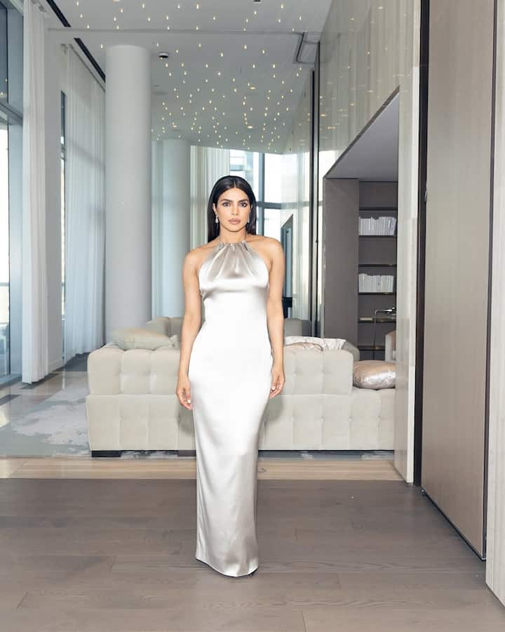 Her floor-length number featured a halter neckline that gracefully gathered at the collarbone.