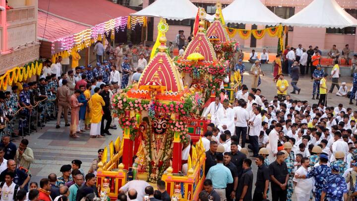 Security personnel and devotees during the 148th Rath Yatra of Lord Jagannath, in Ahmedabad. (Image Source: PTI Images)