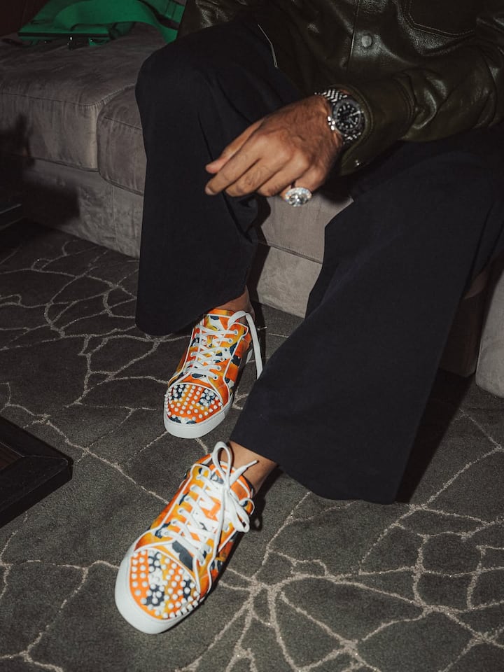 On his face was printed orange and navy christian louboutin sneakers from the otis careey collection.