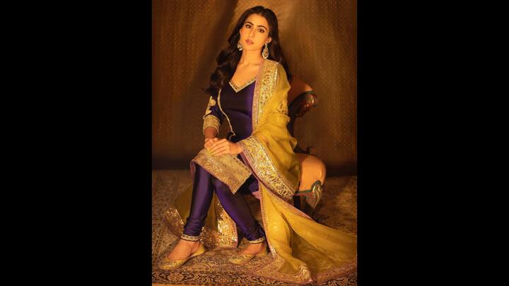1. Purple Suit Look: Draped in elegance and bathed in royal hues, Sara Ali Khan looked stunned in a purple kurta set. The rich fabric added a touch of opulence while the shimmering borders elevated the ensemble to festive perfection. She added a mustard-yellow dupatta for a contrasting look. The intricate gota patti and mirror work exuded regal charm with a contemporary twist. The actress paired her look with yellow juttis and statement earrings that seamlessly blended into the glamorous aesthetic. (Image Source: Instagram/@saraalikhan95)