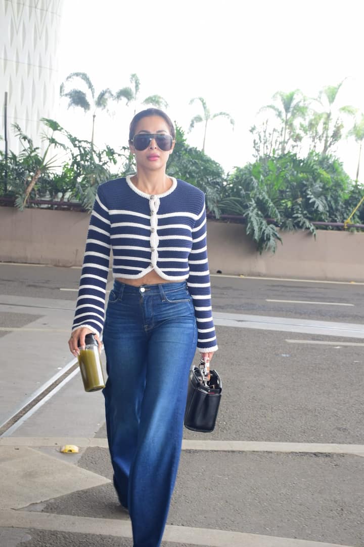 Malaika has completed her look light makeup, glasses on the eyes and bun in hair.