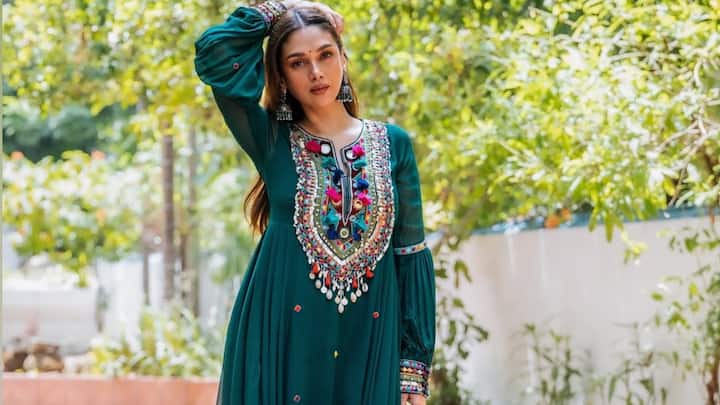 Aditi Rao Hydari’s green kurta set featured intricate embroidery on the neckline and cuffs, enhanced with mirror work, tassels, and cowrie shell beads. Paired with a flared palazzo, her look blends festive elegance with artistic detail. (Image Source: Instagram/ aditiraohydari)