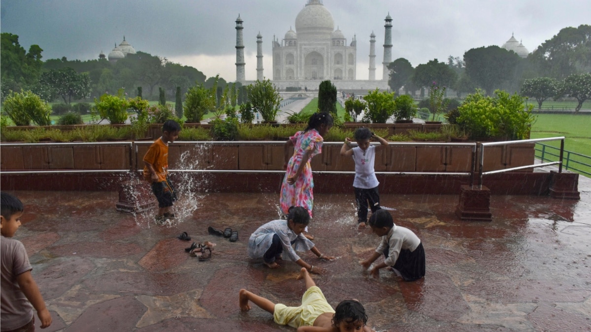 Uttar Pradesh Weather Alert: Heavy Rain Continues, IMD Forecasts Another Week Of Showers Children play in the rain at Taj Mahal in Agra.