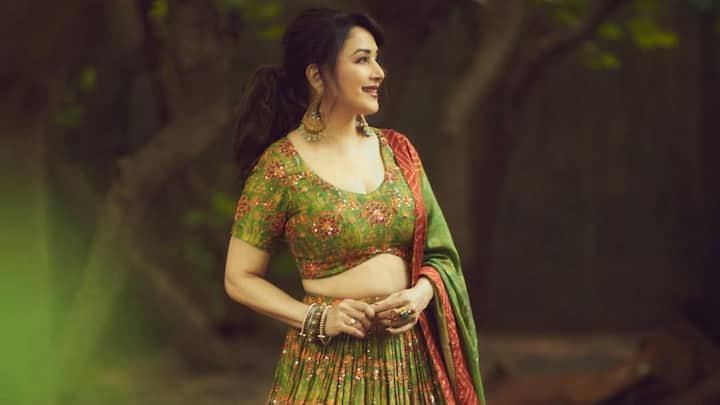 Madhuri is stunning in this flared maxi skirt and V-neck blouse, accessorised with a double-tone bandhani dupatta. Her outfit perfectly blends floral, hand-embellished, and bandhani for an ethereal look. (Image Source: Instagram/ madhuridixitnene)