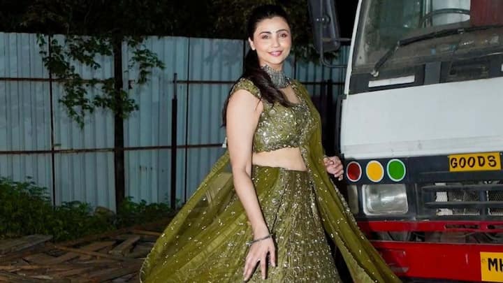 Daisy Shah shines in this dark green embroidery lehenga, accessorised with a choker and light makeup, a poised selection for classic Teej celebrations. (Image Source: Instagram/ poojapeshoriaofficial)