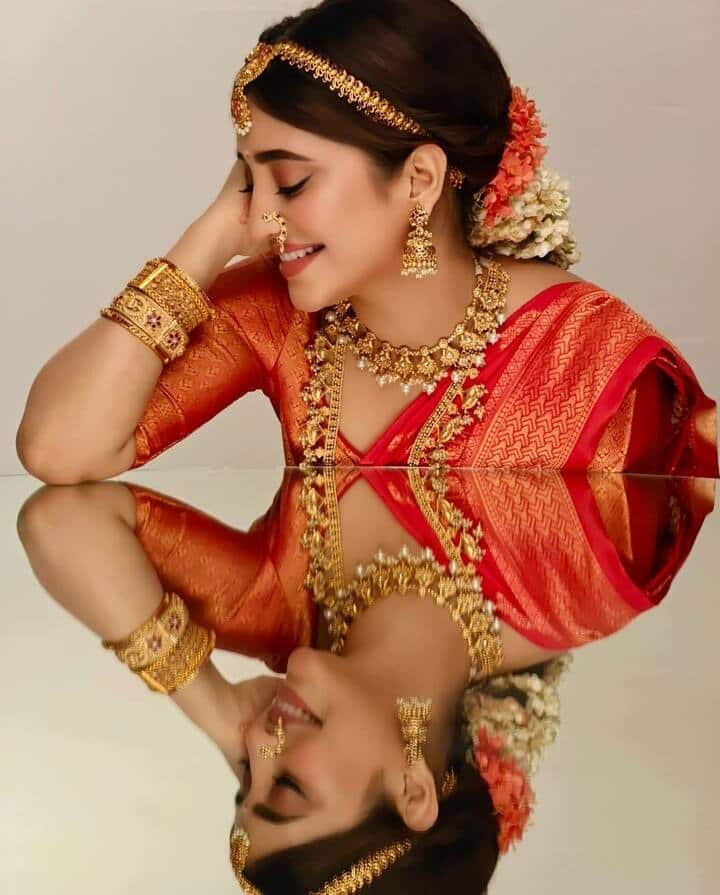 शिवांगी का साउथ इंडियन लुक फैंस को खूब पसंद आ रहा है। उन्होंने लाल सिल्क की साड़ी और हैवी ज्वैलरी पहनी हुई है।