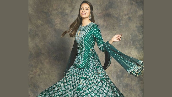Shraddha Kapoor dazzles in this dark green sequined lehenga complemented with an elongated embellished top. The fit-and-flare design makes it a classy celebration option. (Image Source: Instagram/ pinkvilla)